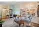 Bright living room with large windows, elegant chandelier, and comfortable seating arrangement at 7810 Flintlock Dr, Port Richey, FL 34668