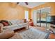 Cozy sun room featuring a comfortable sofa, stylish rug, and access to screened in porch at 7810 Flintlock Dr, Port Richey, FL 34668