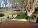 Backyard scene with lawn, trees and lake at 820 Newberger Rd, Lutz, FL 33549