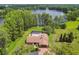 Aerial view of home featuring swimming pool, covered patio, 2-car garage, long driveway and manicured landscaping at 820 Newberger Rd, Lutz, FL 33549