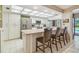 Bright kitchen featuring stainless steel appliances and a cozy breakfast bar with seating at 820 Newberger Rd, Lutz, FL 33549