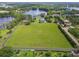 Expansive green land for sale with lake access and black asphalt surrounding the property at 820 Newberger Rd, Lutz, FL 33549