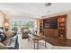 Cozy living room with a large entertainment center and sliding doors leading to the pool area at 820 Newberger Rd, Lutz, FL 33549