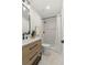 Updated bathroom featuring a modern vanity, sleek fixtures, and a tiled shower at 8485 Pelican Ln, Seminole, FL 33777
