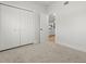 Cozy bedroom featuring a closet, plush carpet, and ensuite bathroom entrance at 8485 Pelican Ln, Seminole, FL 33777