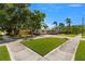 Well-manicured front yard with green lawn and sidewalk at 8485 Pelican Ln, Seminole, FL 33777