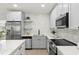 Newly renovated kitchen with stainless steel appliances, white cabinets, and modern finishes at 8485 Pelican Ln, Seminole, FL 33777