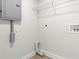 Clean laundry room showing an electrical panel and washer hookups at 8485 Pelican Ln, Seminole, FL 33777