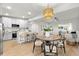 Open concept living space with modern kitchen, dining area, and hardwood floors at 8485 Pelican Ln, Seminole, FL 33777