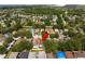 Aerial view of a neighborhood, showcasing tree-lined streets and nearby lakes at 8526 Quarter Horse Dr, Riverview, FL 33578