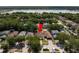 Aerial view of a home in a neighborhood near a lake, surrounded by lush greenery at 8526 Quarter Horse Dr, Riverview, FL 33578