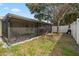 View of a screened in patio, backyard grass and partial view of home at 8526 Quarter Horse Dr, Riverview, FL 33578