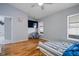 Bedroom with hardwood floors, a ceiling fan, and natural light from the window at 8526 Quarter Horse Dr, Riverview, FL 33578