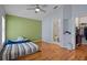 Bedroom featuring wood flooring, a ceiling fan, ensuite bathroom access, and a walk-in closet for storage at 8526 Quarter Horse Dr, Riverview, FL 33578