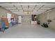 Spacious garage with tiled flooring, ample storage space, and a convenient side door entrance at 8526 Quarter Horse Dr, Riverview, FL 33578