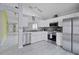 Updated kitchen with stainless steel appliances, stylish gray backsplash, and modern white cabinets at 8526 Quarter Horse Dr, Riverview, FL 33578