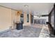 Covered patio with brick flooring, including a stone bar with stools, and a fan at 8526 Quarter Horse Dr, Riverview, FL 33578
