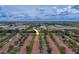 Aerial view of a community featuring single-story homes with red tile roofs surrounded by trees and landscaped grounds at 8701 40Th N Ln, Pinellas Park, FL 33782