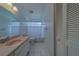 Bathroom features vanity with white cabinets, tile floor, and ample lighting at 8701 40Th N Ln, Pinellas Park, FL 33782