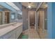 Bathroom with a vanity, sink, mirrors, and a shower stall at 8701 40Th N Ln, Pinellas Park, FL 33782