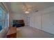 Spacious bedroom with a large window, closet and a ceiling fan with light fixture at 8701 40Th N Ln, Pinellas Park, FL 33782