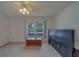 Sunny bedroom with a closet, window, and fan with light fixture at 8701 40Th N Ln, Pinellas Park, FL 33782