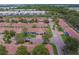 Aerial view of well-maintained single-story residences with red tile roofs and mature trees lining the streets in a serene neighborhood at 8701 40Th N Ln, Pinellas Park, FL 33782