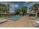 Inviting community pool area with lounge chairs and shade structures at 8701 40Th N Ln, Pinellas Park, FL 33782