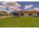 Villa featuring a red barrel tile roof, and a blue awning above the windows at 8701 40Th N Ln, Pinellas Park, FL 33782
