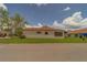 Villa featuring a manicured lawn, mature landscaping, and a red fire hydrant at 8701 40Th N Ln, Pinellas Park, FL 33782