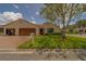 Villa with a well-manicured lawn, barrel tile roof, and mature landscaping at 8701 40Th N Ln, Pinellas Park, FL 33782