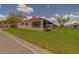 Villa featuring a red barrel tile roof, blue awning, and manicured landscaping at 8701 40Th N Ln, Pinellas Park, FL 33782