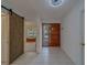 Bright foyer features a decorative wooden door, tile flooring, and a rustic barn door at 8701 40Th N Ln, Pinellas Park, FL 33782