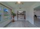 Open-concept living room flows into kitchen and study area, with large windows at 8701 40Th N Ln, Pinellas Park, FL 33782