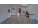 Open-concept living room with wood flooring, natural light, and neutral paint at 8701 40Th N Ln, Pinellas Park, FL 33782