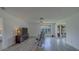 Large living room with wood floors and a bright window at 8701 40Th N Ln, Pinellas Park, FL 33782