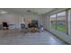 Well-lit living room with neutral colors and a view of the yard at 8701 40Th N Ln, Pinellas Park, FL 33782
