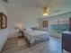 Cozy bedroom with a large window, a comfortable bed, and bright lighting at 8701 40Th N Ln, Pinellas Park, FL 33782