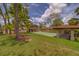 Beautifully maintained shuffleboard courts and well manicured green grass area with mature trees at 8701 40Th N Ln, Pinellas Park, FL 33782