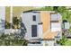 Aerial view of a home with solar panels, backyard, and a cozy firepit area at 9056 108Th Ave, Seminole, FL 33777