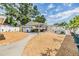Spacious backyard with a covered patio, outdoor seating, and mature landscaping at 9056 108Th Ave, Seminole, FL 33777