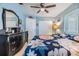 Bright bedroom with floral bedspread, a ceiling fan, a dark wood dresser and ample closet space at 9056 108Th Ave, Seminole, FL 33777