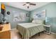 Relaxing bedroom with light green walls, a ceiling fan, a comfortable bed, and a sunlit window at 9056 108Th Ave, Seminole, FL 33777
