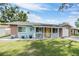 Charming single-story home with a sunny yellow door and stone accents at 9056 108Th Ave, Seminole, FL 33777