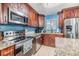 Modern kitchen featuring stainless steel appliances, granite countertops, and ample cabinet space at 9056 108Th Ave, Seminole, FL 33777