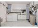 Laundry room with washer, dryer, utility sink, and plenty of storage space at 9056 108Th Ave, Seminole, FL 33777