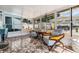 Bright sun room featuring tile floors, large windows, and comfortable seating area at 9056 108Th Ave, Seminole, FL 33777