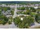 An aerial view of neighborhood streets lined with homes and mature trees under a blue sky at 9310 N 12Th St, Tampa, FL 33612