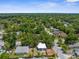 An aerial view of a neighborhood with many mature trees and single story homes at 9310 N 12Th St, Tampa, FL 33612