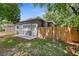 Backyard featuring a gray single story home with a privacy fence and concrete patio at 9310 N 12Th St, Tampa, FL 33612